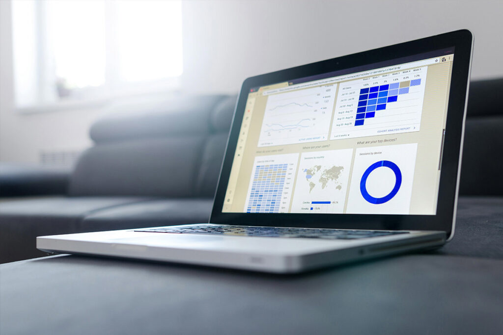 A laptop displaying analytics and marketing performance data.